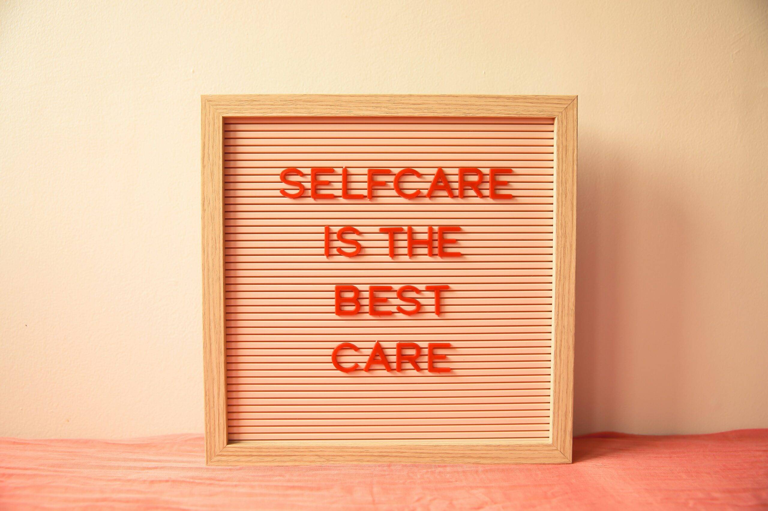 A letterboard sign stating Self Care is the Best Care. Photo by Ava Sol